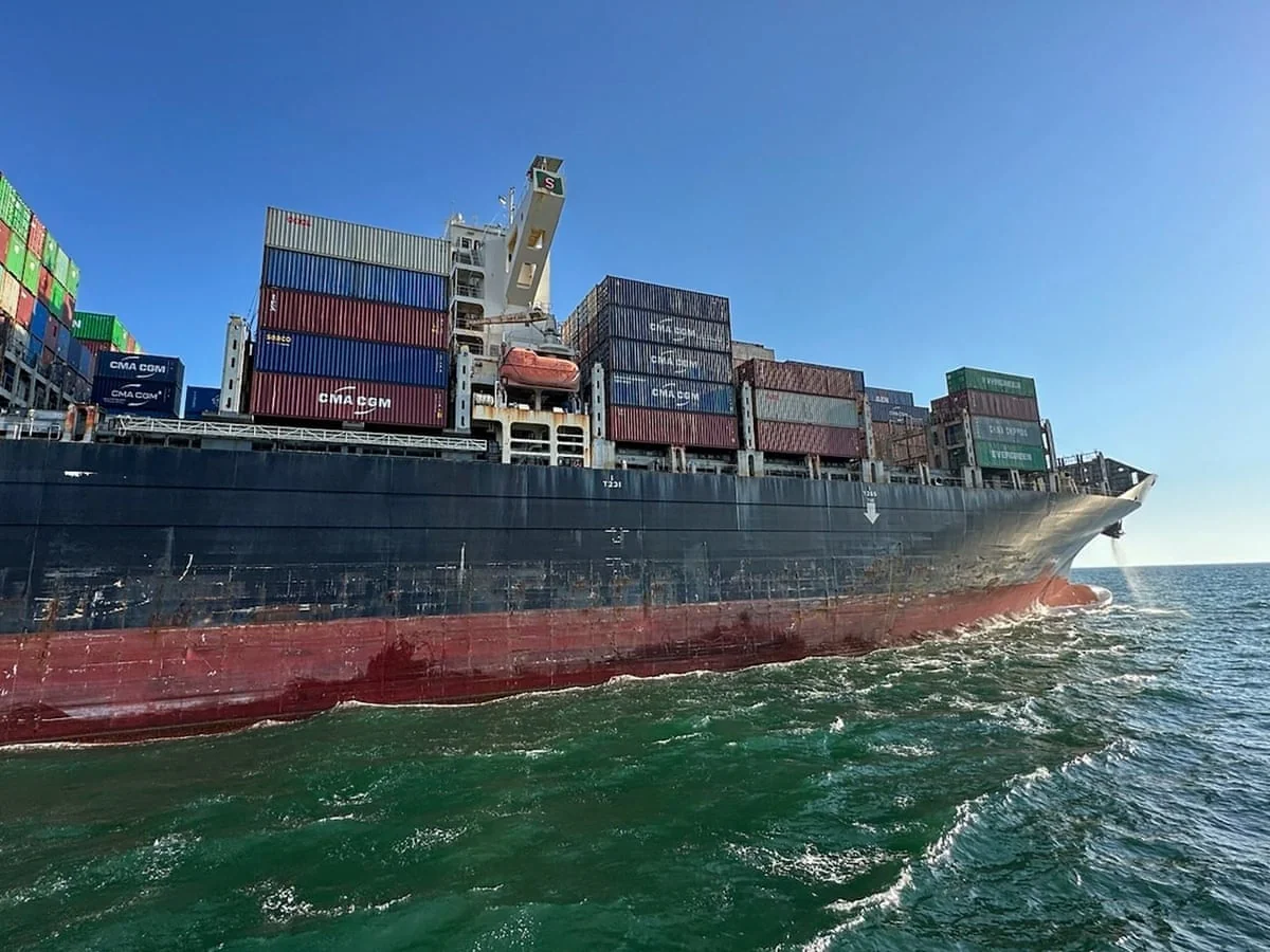 Велике контейнерне судно CMA CGM з вантажем пливе морем під чистим небом